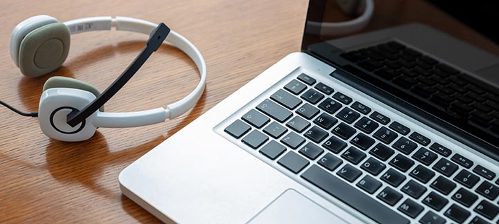 Laptop computer and a pair of headphones sitting on a desk